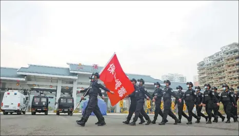  ?? PHOTOS PROVIDED TO CHINA DAILY ?? Members of the mobile antidrug brigade in Baoshan, Yunnan province, march to their station in April.