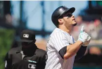  ?? DAVID ZALUBOWSKI/ASSOCIATED PRESS ?? Colorado’s Nolan Arenado crosses home plate after hitting a three-run homer against the Cubs on Sunday.