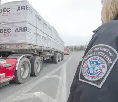  ?? RYAN REMIORZ / THE CANADIAN PRESS ?? A truck carrying wood goes through the customs checkpoint on Tuesday at Champlain, N.Y.