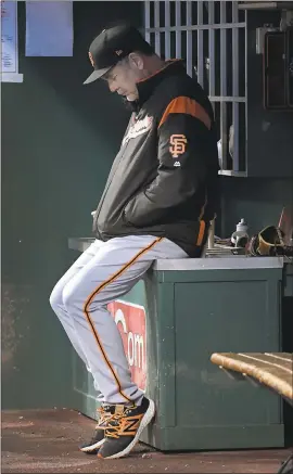  ?? MICHAEL E. KEATING — ASSOCIATED PRESS FILE PHOTO ?? San Francisco Giants manager Bruce Bochy sits alone in the dugout during the fifth inning of a baseball game against the Cincinnati Reds, Saturday, May 6, 2017, in Cincinnati.