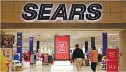  ?? —AP ?? PITTSBURG: Shoppers walk into a Sears store in Pittsburgh. Sears Holdings Corp reported a loss of $607 million in its fiscal fourth quarter.