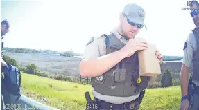  ?? DAMIAN GILETTO/DELAWARE NEWS JOURNAL ?? Body camera footage shows a Liberty County deputy examining a gift given to a member to the Delaware State University women’s lacrosse team. The officers searched the team’s luggage and belongings during a traffic stop late last month.