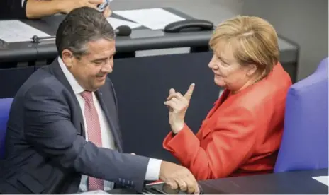  ?? MICHAEL KAPPELER/DEUTSCHE PRESSE-AGENTUR ?? German Chancellor Angela Merkel, seen with Foreign Minister Sigmar Gabriel on Tuesday, says her “calm is a strength” when dealing with world leaders.