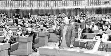  ??  ?? In this handout photograph taken and released by Pakistan’s Press Informatio­n Department (PID), Imran Khan (right) speaks during a joint session at Parliament House in Islamabad. — AFP photo