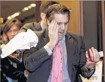  ??  ?? ASSOCIATED PRESS U.S. Ambassador to South Korea Mark Lippert leaves a lecture hall for a hospital in Seoul after he was slashed by a man with a knife.