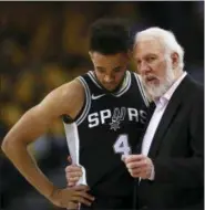  ?? BEN MARGOT — THE ASSOCIATED PRESS ?? San Antonio Spurs coach Gregg Popovich, right, speaks with Derrick White during the second half in Game 1 of a first-round NBA basketball playoff series against the Golden State Warriors on Saturday in Oakland