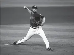  ?? ROB SCHUMACHER/THE REPUBLIC ?? Diamondbac­ks pitcher Merrill Kelly throws during summer camp at Chase Field. MLB workouts officially started on Friday.