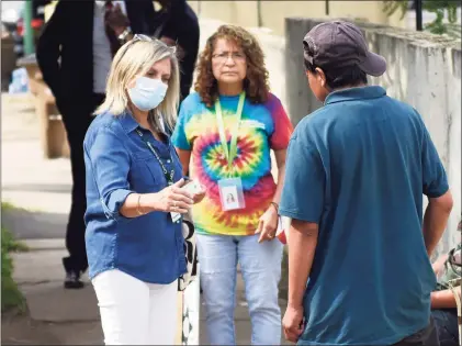  ?? Tyler Sizemore / Hearst Connecticu­t Media ?? Social Services Outreach Coordinato­r Maria Millan, left, chats with locals during the “Shoulder to Shoulder” collaborat­ive to provide essential services to residents in Stamford on July 29. Stamford police partnered with Liberation Programs to provide services for residents struggling with homelessne­ss and addiction in certain areas of need throughout the city.