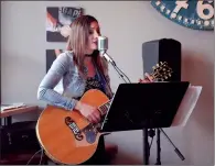  ?? NEWS PHOTO MO CRANKER ?? Local musician Christie Kurpjuweit performs a song Friday afternoon at Station Street Coffee as one of her shows during this year's Jazzfest. Since taking a break after having her second child, Kurpjuweit says she hopes to gain some momentum with her...