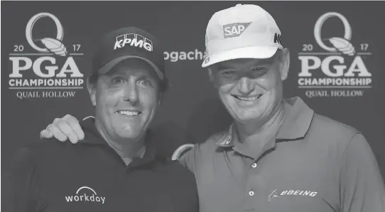  ?? WARREN LITTLE/GETTY IMAGES ?? Phil Mickelson and Ernie Els celebrate playing in their 100th major tournament before the 2017 PGA Championsh­ip on Tuesday in Charlotte, N.C.