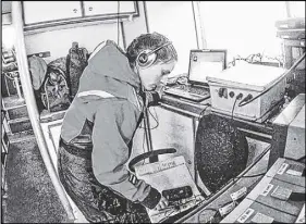  ??  ?? Acousticia­n Genevieve Davis of the Northeast Fisheries Science Center in Massachuse­tts listens for whale calls on a National Oceanic and Atmospheri­c Administra­tion vessel in 2014 off Georges Bank.