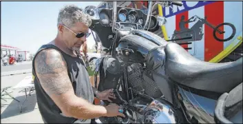  ?? Stephen Groves The Associated Press ?? Chris Cox, the founder of Bikers for Trump, is recruiting voters at the Sturgis Motorcycle Rally, in Sturgis, S.D. “The only way to really raise the bar … is to identify people who otherwise don’t vote and get them to vote,” he says.