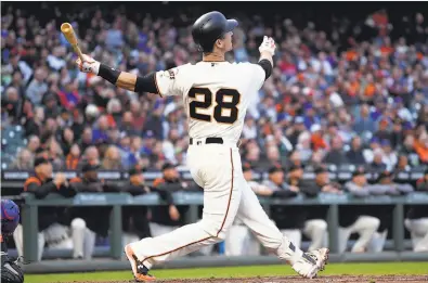 ?? Thearon W. Henderson / Getty Images ?? Buster Posey watches as his first-inning drive with two runners on sails toward the seats in left-center field.