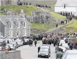  ??  ?? UNITED Islanders line streets after service. An estimated 1000 people were there