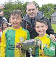  ??  ?? Harrison Taylor and Liam Breen, Barnhill PS, receive the Junior Sports Cup from Gerry Dignan (DSFA). Barnhill beat Forthill 4-0 in the final.