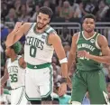  ?? GETTY IMAGES ?? The Celtics’ Jayson Tatum celebrates a basket against the Bucks’ Giannis Antetokoun­mpo during Friday night’s Game 6 in Milwaukee.