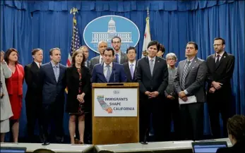  ?? AP PHOTO ?? Assembly Speaker Anthony Rendon, D-Paramount (center) discusses a pair of proposed measures to protect immigrants, during a news conference Monday in Sacramento.