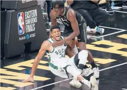  ?? KEVIN C. COX/GETTY ?? Giannis Antetokoun­mpo hyperexten­ded his left knee Tuesday during the Bucks’ Game 4 loss to the Hawks in the Eastern Conference finals. The series is tied 2-2.