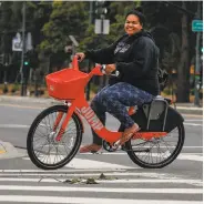  ??  ?? Stella Maloa, a mentor at Project Bayview Women’s Home, rides one of the new Jump electric bicycles.