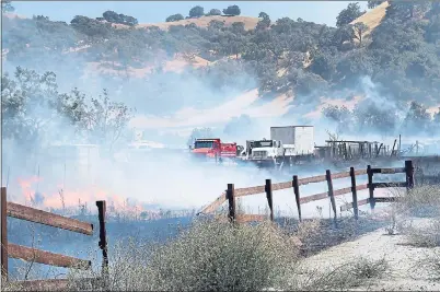  ?? PHOTO BY JASON GREEN ?? A brush fire burns near Hale and Live Oak avenues in Morgan Hill on Tuesday. At least four horses were found dead, according to Cal Fire.