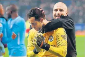  ?? AFP ?? ▪ Manchester City manager Pep Guardiola (right) celebrates with goalkeeper Claudio Bravo after winning the English League Cup quarterfin­al against Leicester City on Tuesday.