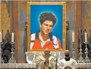  ?? GREGORIO BORGIA/AP ?? An image of Carlo Acutis is seen during his beatificat­ion ceremony Saturday in St. Francis Basilica in Assisi, Italy.