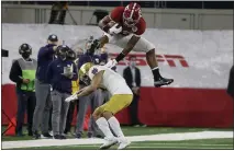  ?? MICHAEL AINSWORTH — THE ASSOCIATED PRESS ?? Alabama running back Najee Harris hurdles Notre Dame cornerback
Nick McCloud as he carries the ball for a long gain in the first half of the Rose Bowl on Friday.