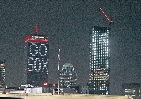  ?? STUART CAHILL / BOSTON HERALD ?? LIGHT SHOW: The Prudential Tower displayed its support for the Red Sox during the World Series.