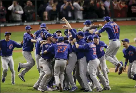  ?? CHARLIE RIEDEL — THE ASSOCIATED PRESS FILE ?? The Chicago Cubs celebrate after Game 7 of the Major League Baseball World Series against the Cleveland Indians in Cleveland. The Cubs won 8-7 in 10 innings to win the series 4-3. Baseball’s lovable losers were favored to finally break through after...