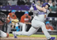  ?? Michael Laughlin The Associated Press ?? Max Muncy swings through a pitch for one of the Dodgers’ 10 strikeouts against Sandy Alcantara, who notched a 111-pitch six-hitter Saturday night in the Marlins’ 2-1 home win.