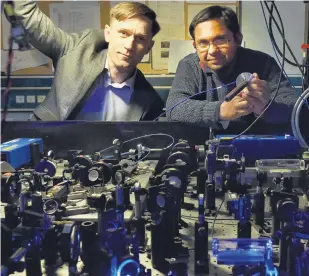  ?? PHOTO: GREGOR RICHARDSON ?? New device . . . Physicists (from left) Prof Niels Kjaergaard and Dr Amita Deb, holding a radio antenna, reflect on new quantum radio technology.