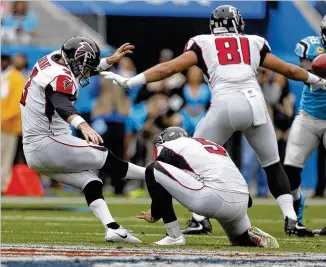  ?? BOB LEVERONE / AP ?? The Falcons’ Matt Bryant (left) kicks a field goal against the Carolina Panthers in the first half of their game in Charlotte on Sunday. His status for Sunday’s game against Dallas is uncertain.