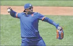  ?? KATHY WILLENS ?? New York Mets left fielder Yoenis Cespedes stretches out to throw the ball as he waits for his turn in the batting cage during the afternoon session of a summer baseball training camp workout at Citi Field, Thursday, July 9, 2020, in NewYork.