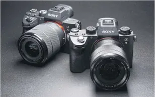  ?? BLOOMBERG ?? A Sony Alpha a7III mirrorless digital camera mounted with an FE 28-70mm f/3.5-5.6 OSS standard zoom lens, left, and an Alpha a9 mirrorless digital camera mounted with an FE 24-70mm f/4 ZA OSS standard zoom lens, manufactur­ed by Carl Zeiss AG, are arranged for a photograph in Kawasaki, Kanagawa prefecture, Japan.