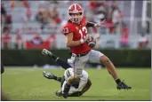  ?? BRETT DAVIS – THE ASSOCIATED PRESS ?? Georgia's Stetson Bennett, who threw two TD passes, scrambles away from Vanderbilt linebacker CJ Taylor.