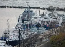  ?? (Alla Dmitrieva/Reuters) ?? SEIZED UKRAINIAN naval ships are guarded by Russian Coast Guard vessels in the port in Kerch, near the bridge connecting the Russian mainland with the Crimean Peninsula, in November 2019.