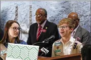  ?? BOB ANDRES PHOTOS /BANDRES@AJC.COM ?? Sara Laine is joined by state legislator­s at a press conference where Girl Scouts presented more than 10,000 signatures that support renaming the Talmadge Memorial Bridge for Girl Scouts founder Juliette Gordon Low.