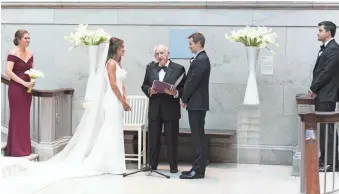  ?? EMILIA JANE PHOTOGRAPH­Y/NADINE GORAND VIA AP ?? Nadine Gorand and husband, Pat Gorand, exchange their wedding vows which were being administer­ed by Nadine’s grandfathe­r, Raymond Oddi.