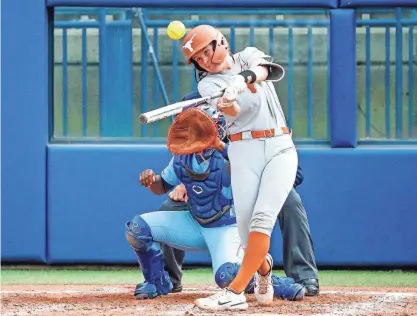  ?? NATHAN J. FISH/THE OKLAHOMAN ?? Texas' Reese Atwood hits a double during a 2023 Big 12 Tournament game at USA Softball Hall of Fame Stadium in Oklahoma City. Atwood's 13 home runs this season lead the team.
