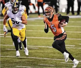  ?? Jamie Sabau / Getty Images ?? Quarterbac­k Ryan Finley threw for a touchdown and ran for another to lead the Bengals to an improbable upset of the Steelers on Monday night in Cincinnati.