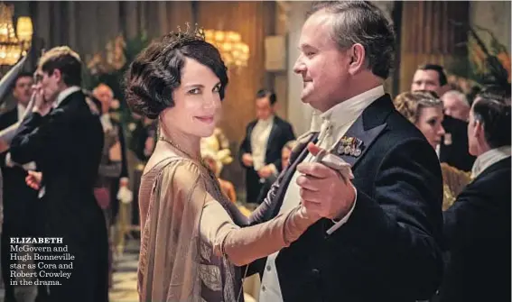  ?? Jaap Buitendijk Focus Features ?? ELIZABETH
McGovern and Hugh Bonneville star as Cora and Robert Crowley in the drama.