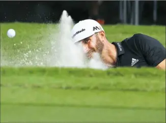  ??  ?? Tour Championsh­ip co-leader Dustin Johnson blasts out of a bunker en route to a third-round 69 Saturday at East Lake Golf Club in Atlanta.