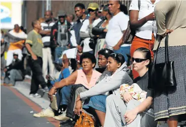  ?? /James Oatway/Sunday Times ?? Desperate: Unemployed people queue for UIF payments outside the Department of Labour in Port Elizabeth. While unemployme­nt rises, hundreds of millions of rand meant for beneficiar­ies of the Employment Creation Fund have not been disbursed.