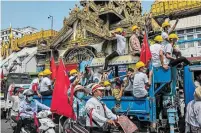  ?? HKUN LAT GETTY IMAGES ?? Protesters wave flags in downtown Yangon, Myanmar, on Monday. The ruling junta warned they were risking their lives.