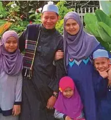  ??  ?? Izrisham Hussin with his wife, Nor Haslin Harun, and their children.