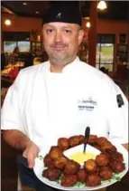  ??  ?? Colin Rayner, chef and owner of the Blu Saffron Bistro located at Volcanic Hills Winery, was busy serving appetizers such as their Indian spice vegetable fritters with curried aioli.