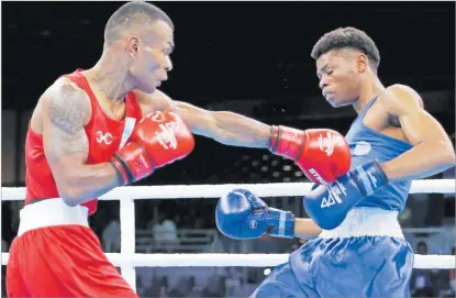  ?? Picture: REUTERS ?? Jone Davule, left, up against Tryagain Morning Ndevelo of Namibia during the men’s 54kg-57kg featherwei­ght fight at the Birmingham 2022 Commonweal­th Games in England.