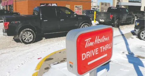  ?? AL CHAREST / POSTMEDIA NEWS ?? In a note to franchisee­s, Tim Hortons said it will “focus on takeout, drive-thru and delivery service (where available)
and will voluntaril­y close all dining room seating in most locations until further notice.”