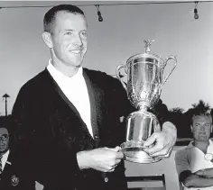  ?? AP Photo/File ?? ■ In this June 17, 1961, file photo, Gene Littler holds the trophy after winning the U.S. Open golf tournament in Birmingham, Mich.