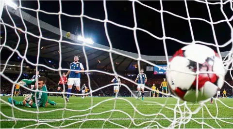  ?? — Reuters ?? Back of the net: Lithuania’s Fedor Chernykh scoring the opening goal against Scotland in the World Cup European Zone Group F qualifying match at Hampden Park on Saturday.